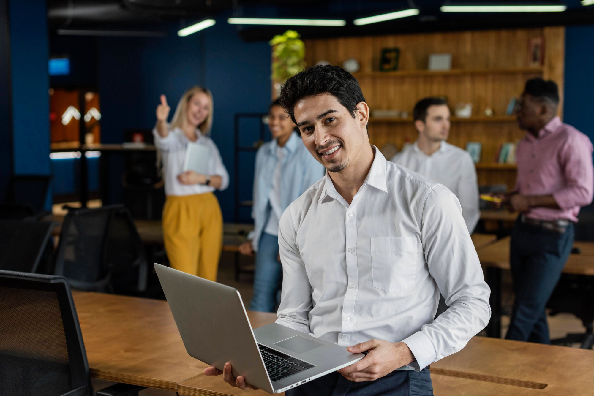 smiley-man-work-holding-laptop-posing